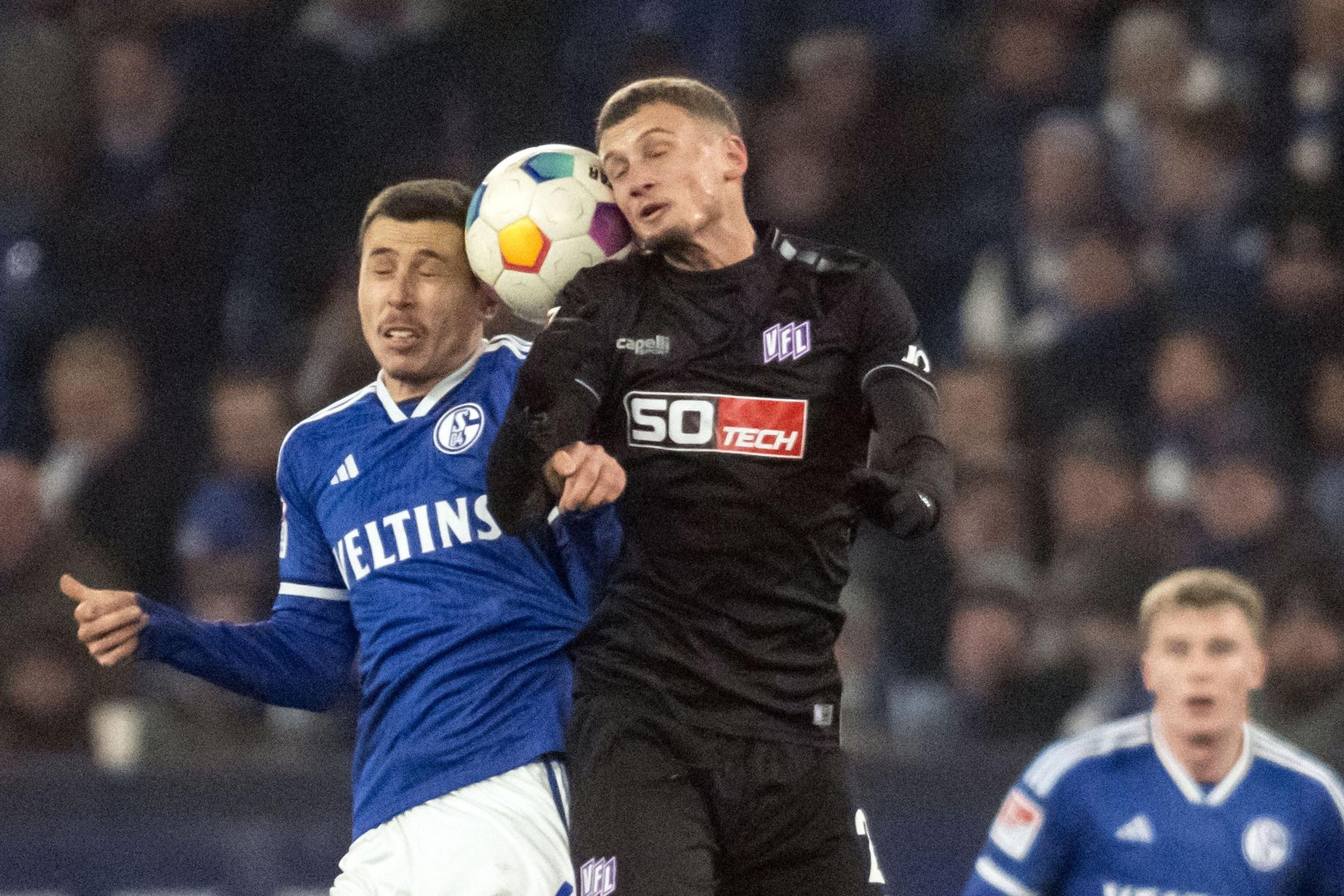Schalkes Ron Schallenberg (l) und Mickaël Cuisance von Osnabrück im Kopfballduell.